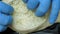 Close vertical view cook hands stretch dough with cheese