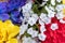 Close view of an assortment of artificial flowers with white forget me nots