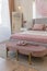 a close view of the bedroom in a modern cozy soft interior in warm delicate pastel pink and beige colors