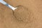 Close view of carob powder on a spoon