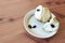 Close view of cherimoya fruit and seeds on small dish