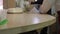 Close view cook wipes wooden table with white napkin