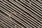 Close view of a dirty cabin air filter at an angle with dried leaves and dirt