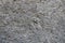 Close view of dusty wall with coarse gray roughcast finish