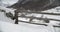 Close view of a entrance of a farm in the mountains covered by snow