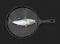 Close view of a fish on a heavy metal skillet