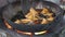 Close view of food being fried in big bowl with oil.