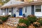 Close view of front porch, suburban home, covered in fall leaves, home maintenance needed with leaf removal