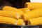 close view on Homemade golden corn cob with butter and salt on table