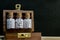 Close view of homeopathy medicine bottles in wooden old box on wood and dark background