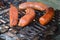 Close view of Italian sausages cooking on tabletop Hibachi grill