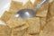 Close view of leftover cereal in bowl with spoon