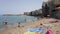 Close view of the local sand beach of Cefalu in Sicily and historical houses