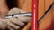 Close view of a male worker using hex wrench for wall works. Stock footage. Master trying to attach metal detail to the