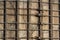 Close view of metal strapping rings around an old concrete silo, vines