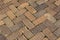 Close view of old brick pavers with decorative pattern laid in a herringbone pattern