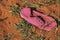 CLOSE VIEW OF SINGLE PINK LOST SHOE IN THE SAND