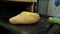 Close view skilled cook puts khachapuri with egg into oven