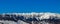 Close view of sunlit Bucegi mountains ridge with steep slopes covered by snow at sunrise, Carpathians mountains range, Romania