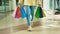 Close view of the woman going on the mall, holding in her hands many colorful paper packages from the shop. Woman after