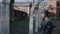 A close view of a young male actor dressed as a German soldier near a barbed wire fence guarding a death camp