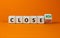 Close won or lost symbol. Turned the wooden cube and changed words Close won to close lost. Beautiful orange background, copy