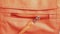 Close zipper of orange bag