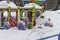 Closed amusement park in winter, a multi-colored carousel covered with a thick layer of snow. City leisure park for children,