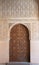 Closed Arabic-style door in the Nasrid palaces of the Alhambra complex in Granada, Spain