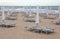 closed beach umbrellas and sun loungers on the sandy beach in wi