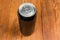 Closed black metal beverage can on the rustic table