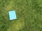 Closed blue book on grass