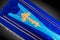 Closed blue coffin covered with cloth on gray background. coffin close-up with gold Church cross.