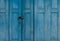 Closed blue wooden door. Vintage front door abstract background. Abandoned old house. Old wooden door texture. Lock the door