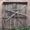 Closed, boarded-up old wooden door. Old abandoned house.