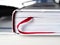 Closed book with a bookmark in the form of a red ribbon close-up.