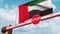 Closed boom barrier with stop sign against the UAE flag. Restricted border crossing or certain ban. 3D rendering