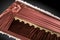 Closed brown coffin covered with elegant cloth on gray background. coffin close-up with gold flowers.