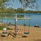 Closed children`s carousel on the shore of a leisure lake, sign with German inscription: playground closed