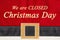 Closed Christmas Day message on red and black Santa suit