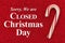 Closed Christmas Day sign with candy cane on red glitter paper