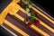 Closed coffin with two red roses covered with elegant cloth isolated on gray background. coffin close-up.