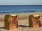 Closed colorful beach chairs at the shore at soft sunlight