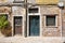 Closed doors of old weathered brick wall residential houses