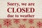 Closed due to weather sign on red and brown snowflake border on beige sherpa material