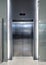 Closed elevator doors glossy illuminated in hotel