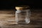 Closed empty glass jar on table