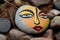 closed eyes painted on a flat stone painted rock art
