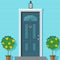 Closed front door with a lantern and ornamental plants in a pot. Vector illustration in flat style.