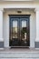 Closed Glossy Black and Glass Front Doors of an Upscale Home